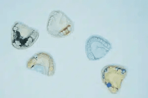 Various types of private denture components laid out on a surface
