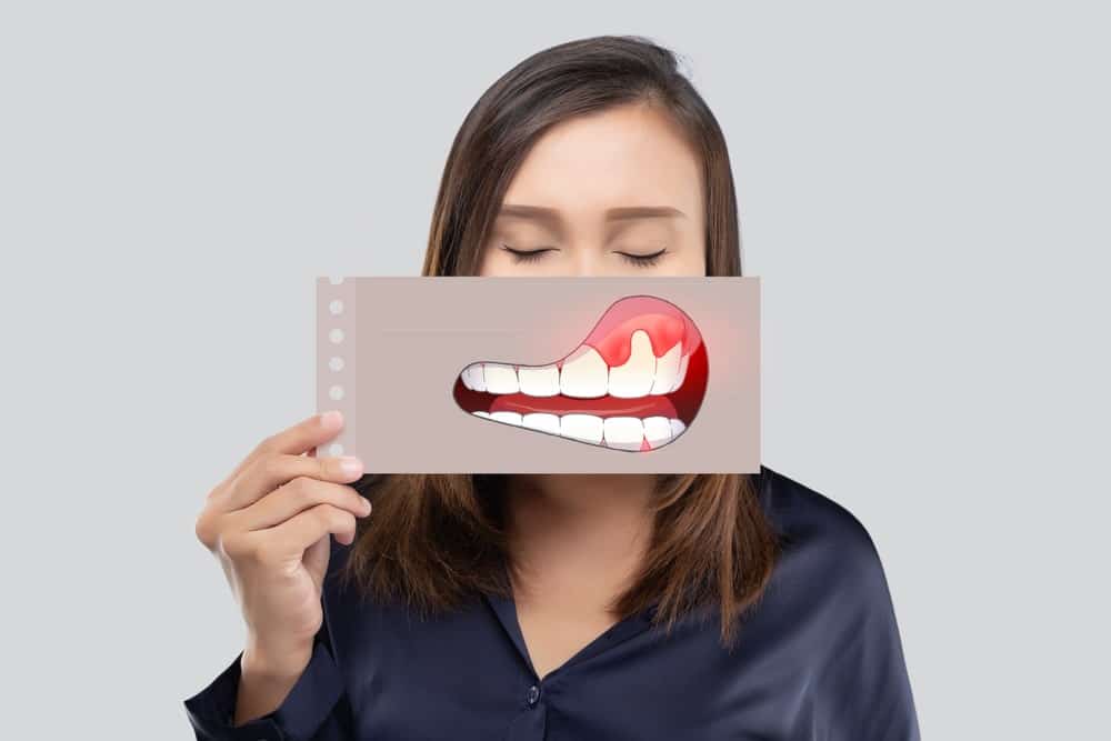 Dentist performing an oral cancer screening examination