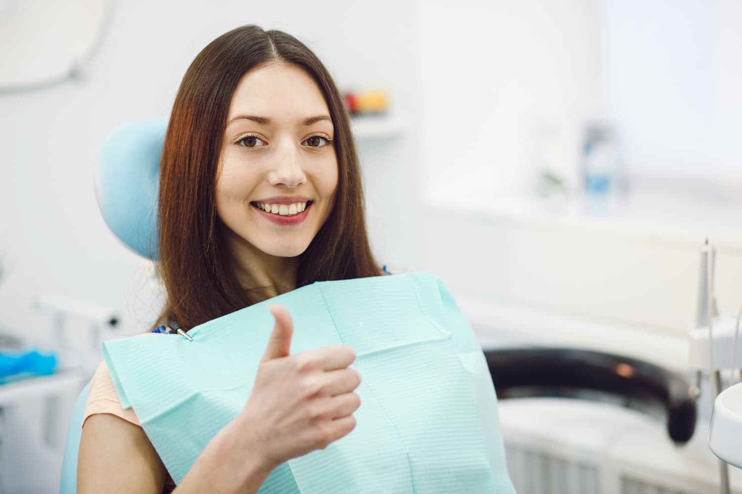 A dentist carefully examines a patient at a clinic.