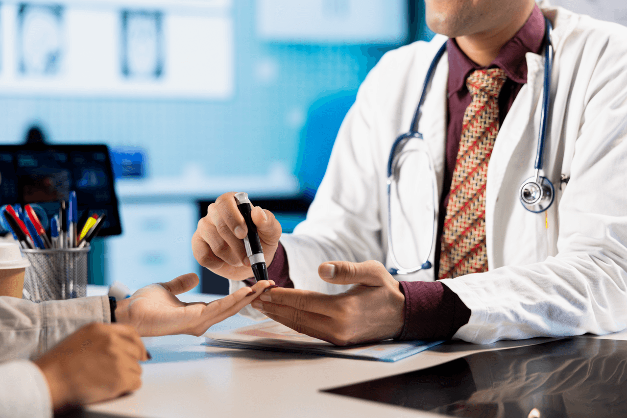 A physician performs a fingertip blood test on a patient