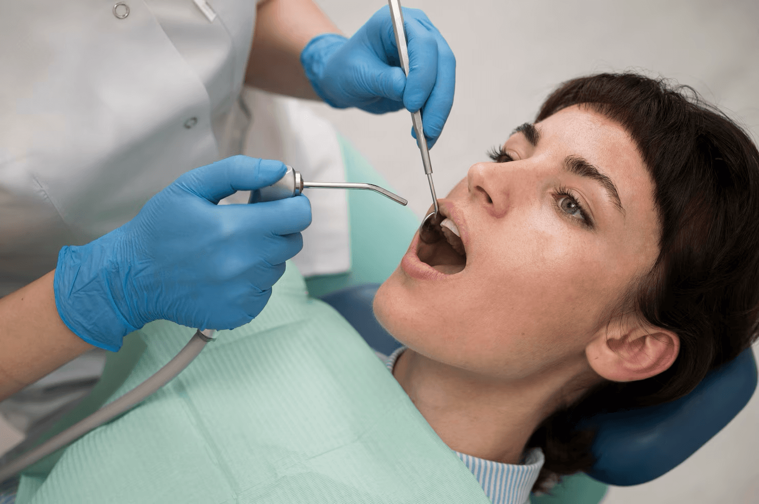 Dental professional performing scaling and root planing treatment