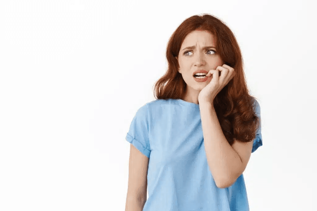 Woman holding her cheek in pain from a loose tooth
