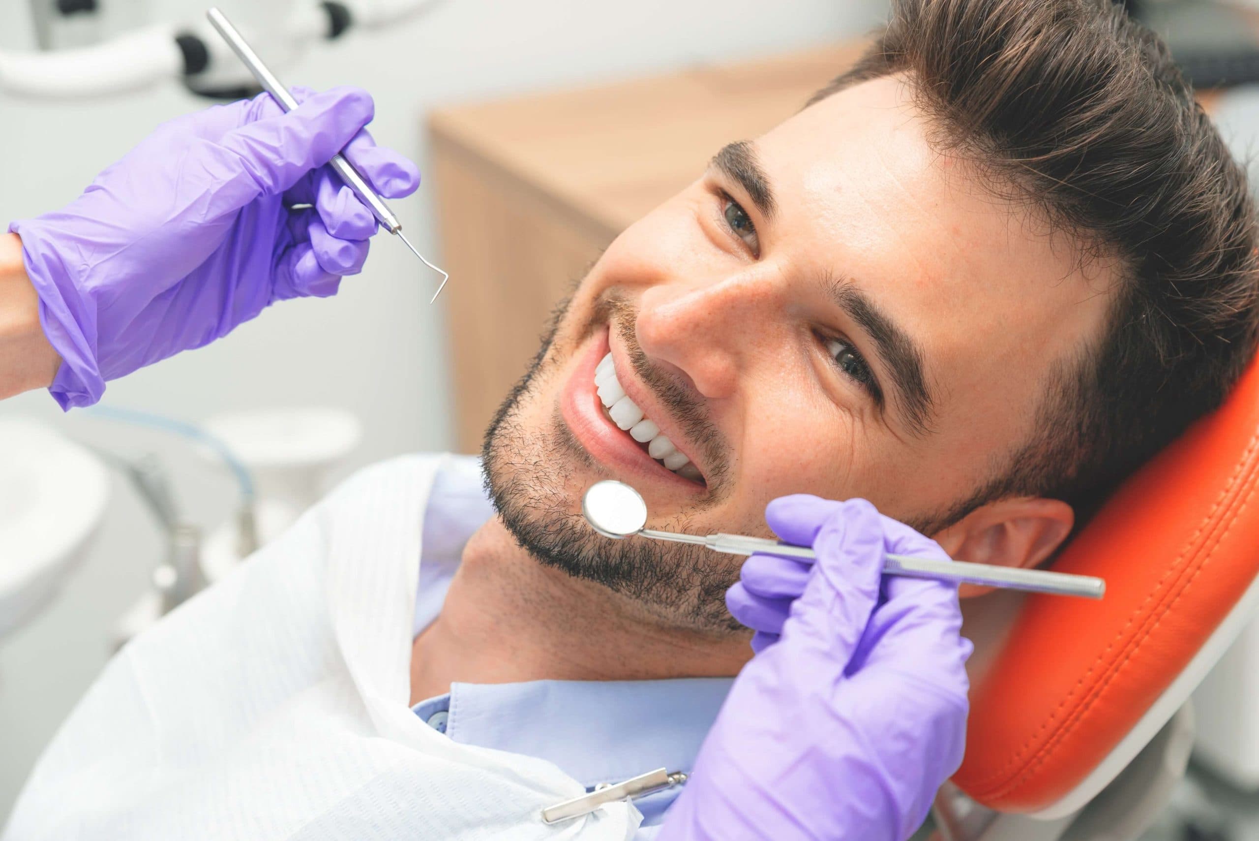 Dentist examining a patient with a broken tooth