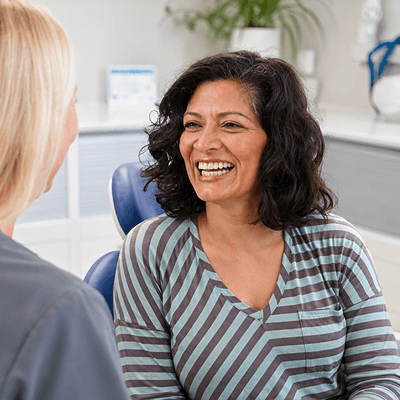 Patient smiling with a member of the team